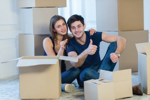 Removal team packing and protecting furniture for a house move