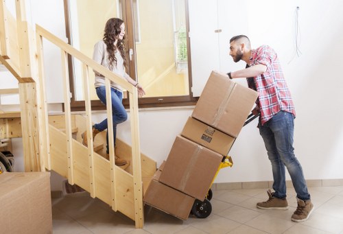 Packed boxes and furniture prepared for flat removals in a Dagenham apartment